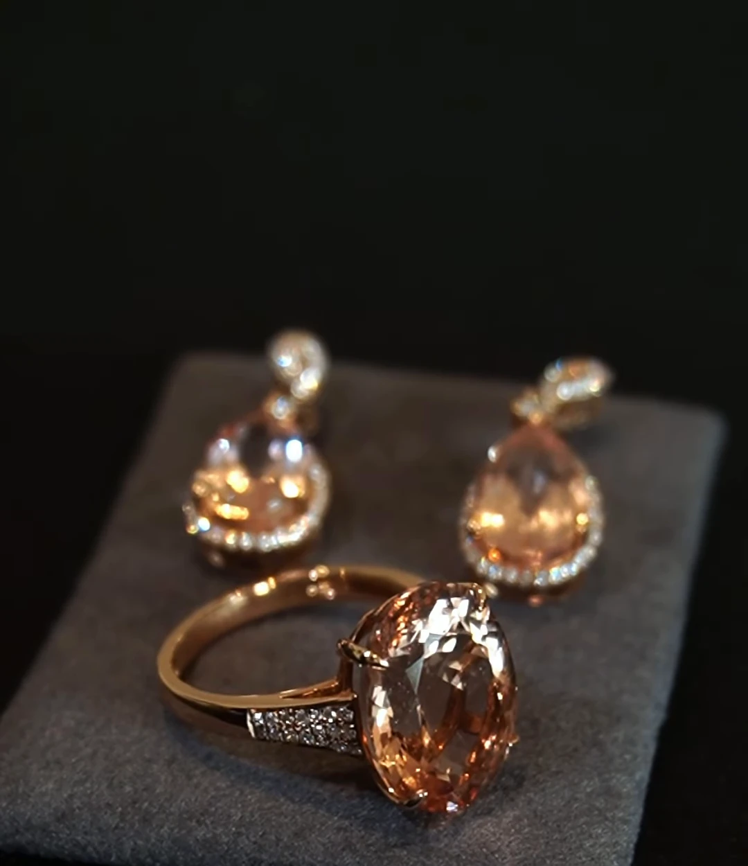 Pendientes y anillo de morganita sobre terciopelo negro